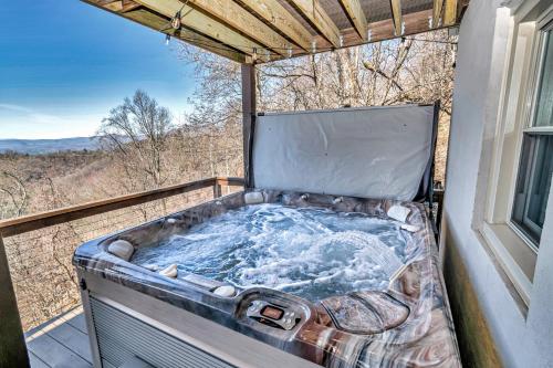a hot tub on the balcony of a house at Calling Me Home in Lenoir