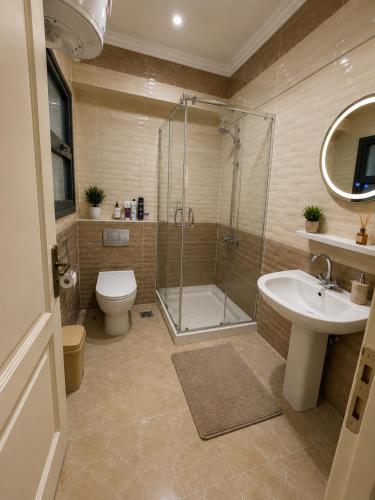 a bathroom with a shower and a toilet and a sink at Stunning view in Madinaty in Madinaty