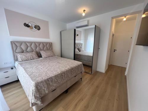 a bedroom with a bed and a large mirror at Guest House Gabi in Srima