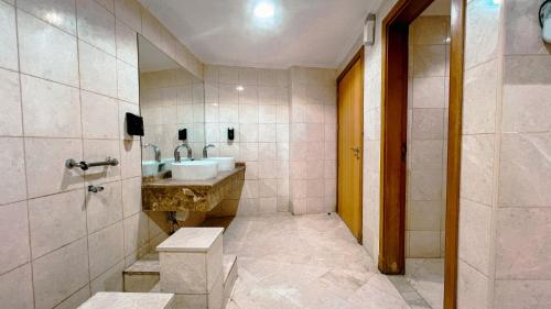 a bathroom with a sink and a mirror and a shower at فندق أوركيد مكة in Mecca