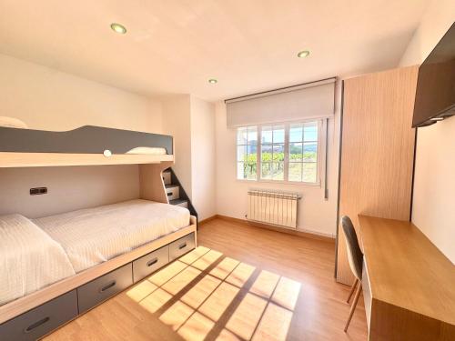 a bedroom with a bunk bed and a window at Balcón da Ría in Cambados