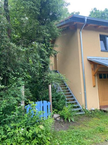 a house with a staircase leading up to a house at Ferienwohnung Zum Bachsee in Chorin