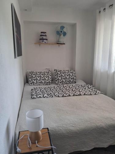 a bedroom with a large bed with a fan at Vila zvjezda 2 in Jajce