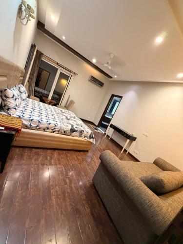 a bedroom with a bed and a couch at Private villa in Lahore