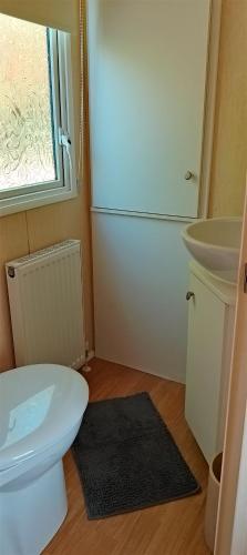 a bathroom with a white toilet and a sink at Stay 6 - Pool - Parking - BeachSide - Pet Friendly in Trimingham