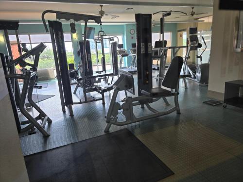 a gym with several tread machines in a room at Domain at Kirby in Houston