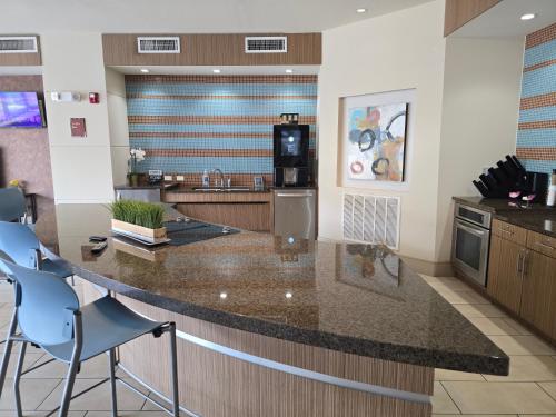 a kitchen with a large island with a counter top at Domain at Kirby in Houston