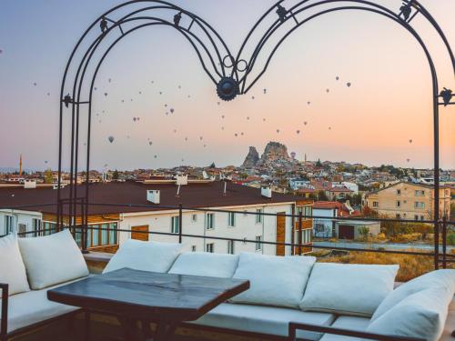 a view of a city from a balcony with hearts at Noble Crown Stone House Cappadocia in Uçhisar