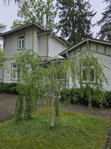 a small tree in front of a house at Baltic Beach Villa I in Jūrmala
