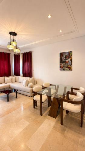 a living room with a couch and a glass table at Modern Apartment - Center of Fez in Fez