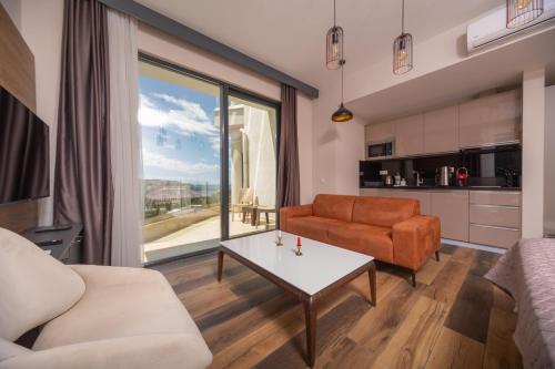 a living room with a couch and a table at Boreti Panorama Residence in Boreti