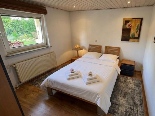 a bedroom with a bed with two towels on it at Hava 2 in Sarajevo