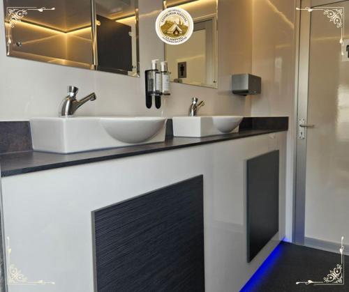 a bathroom with two sinks and two mirrors at Edinburgh Festival Glamping By Stay Social Stays in Edinburgh