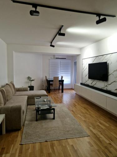 a living room with a couch and a flat screen tv at Diamond Apartment in Strumica