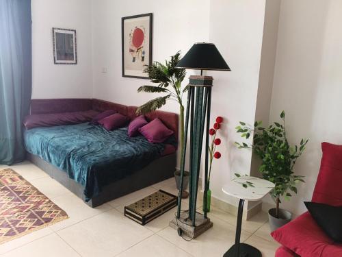 a living room with a couch and a lamp at River House Lodge in Luxor