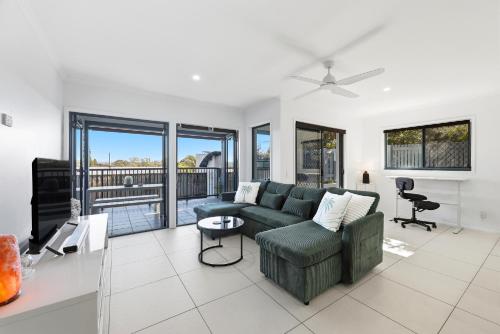 a living room with a couch and a table at Poolside 2-Bed Apartment Near Coolangatta in Gold Coast