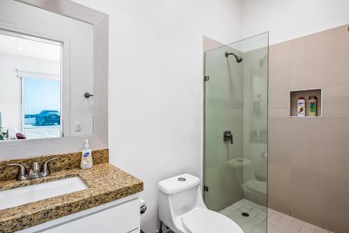 a bathroom with a toilet and a sink and a shower at Dog-friendly Villa with Heated Pool, Hot Tub, Streaming, Partial Ocean Views in Rosarito