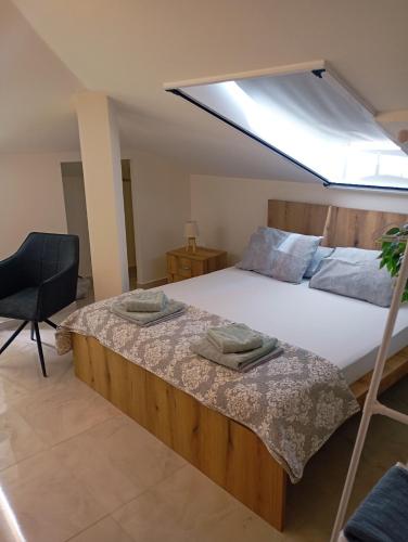 a bedroom with a large bed with a skylight at Luxury suite with Olympus and sea view in Litochoro