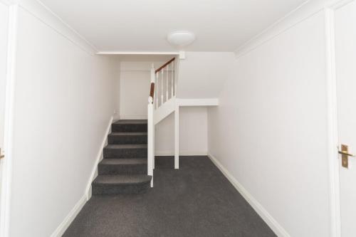 a staircase in a house with white walls at Crescent Mews in Bath