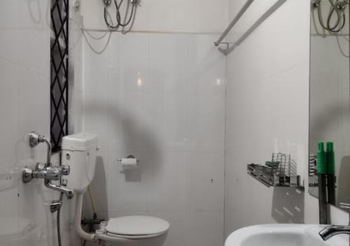 a bathroom with a toilet and a sink at Crossroad in Shillong
