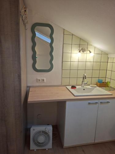 a small kitchen with a sink and a fan at Ferienwohnung Rieder in Wörgl