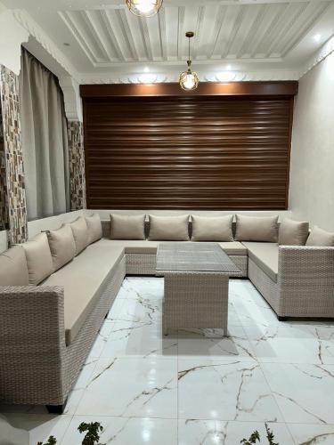 a living room with a couch and a table at Villa ghmate in El Kriet