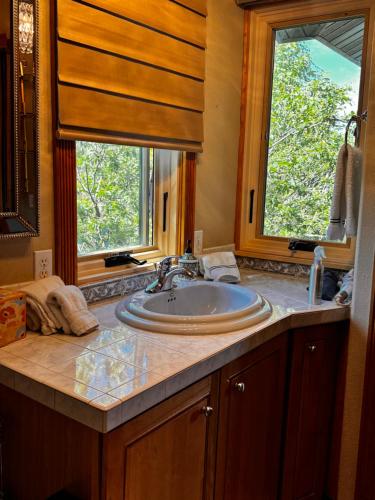 a bathroom with a sink and a window at THE INN Bigfork Bay in Bigfork