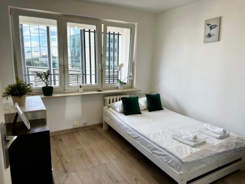 a small bedroom with a bed and a window at Metro Central 3 Rooms Apartment in Warsaw