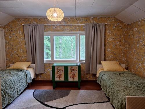 a bedroom with two beds and a window at Large detached house without neighbors in Kouvola