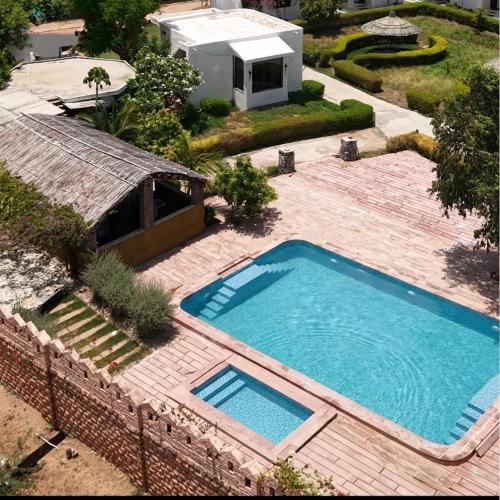 an overhead view of a swimming pool in a backyard at Haveli Expedition & Resort in Ghānerao