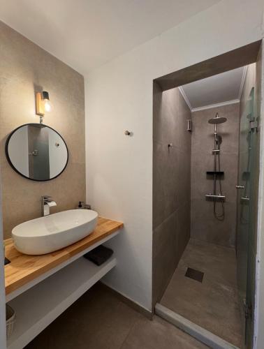 a bathroom with a sink and a shower at Summerscape Studios and Apartments in Corfu