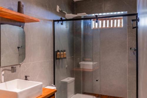 a bathroom with a shower and a sink at GreenHousi Boutique Preá in Prea