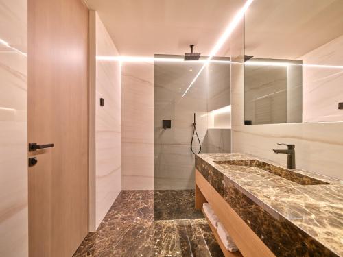 a bathroom with a large sink and a shower at Luxury Apartments La Baia - Penthouse in Torri del Benaco