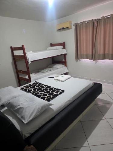 a room with a bed and a ladder and a bunk bed at Hotel Master Blue - Brasília in Ceilândia