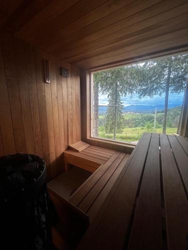 a room with a large window in a sauna at Tiarra Mountain Lodge in Beliş