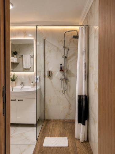 a bathroom with a shower and a sink at Vila Kristina in Negotin