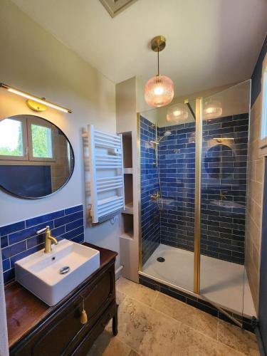 a bathroom with a sink and a shower at La Pastellière - Combrand in Combrand