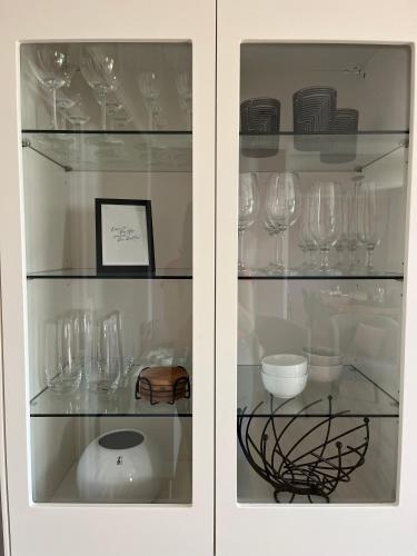 a cabinet filled with wine glasses on display at Haus Blumenglück 2.0 in Herscheid