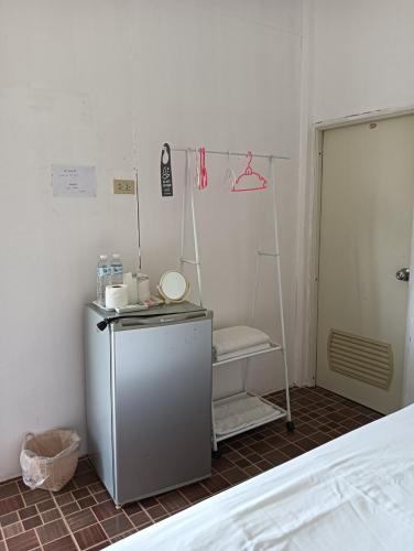 a room with a small refrigerator and a shelf at Pai sunrise camping resort in Pai