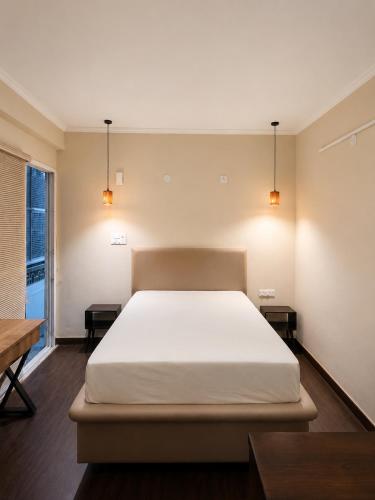 a bedroom with a large bed and two tables at Astha lodge in Solan