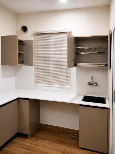 a kitchen with a sink and a window at Astha lodge in Solan