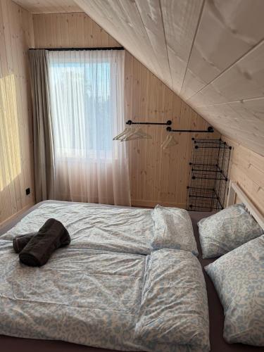 a large bed in a bedroom with a window at Sea Spray Nida in Nida