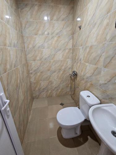 a bathroom with a toilet and a sink at Guesthouse Las Palmas in Ureki