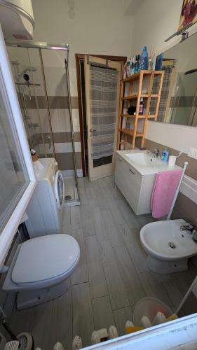 a bathroom with a toilet and a sink at ANDREA - Chiassi in Brescia
