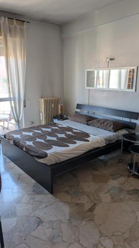 a large bed in a room with a large bedvisor at ANDREA - Chiassi in Brescia