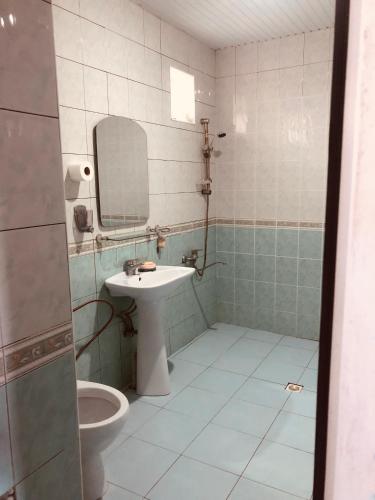a bathroom with a sink and a mirror and a toilet at Wild Caspian coast in Aşağıoba