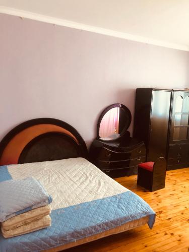 a bedroom with a bed and a mirror at Wild Caspian coast in Aşağıoba