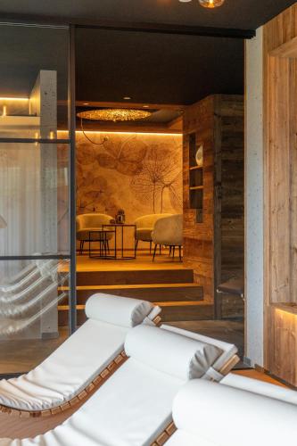 a spa room with a view of a table and chairs at Altmessnerhof in Dobbiaco