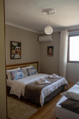 a bedroom with a bed with towels on it at Aldo's apartments in Pogradec
