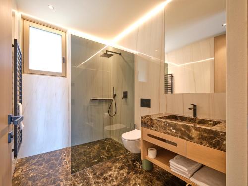 a bathroom with a sink and a toilet at Apartment La Baia in Torri del Benaco